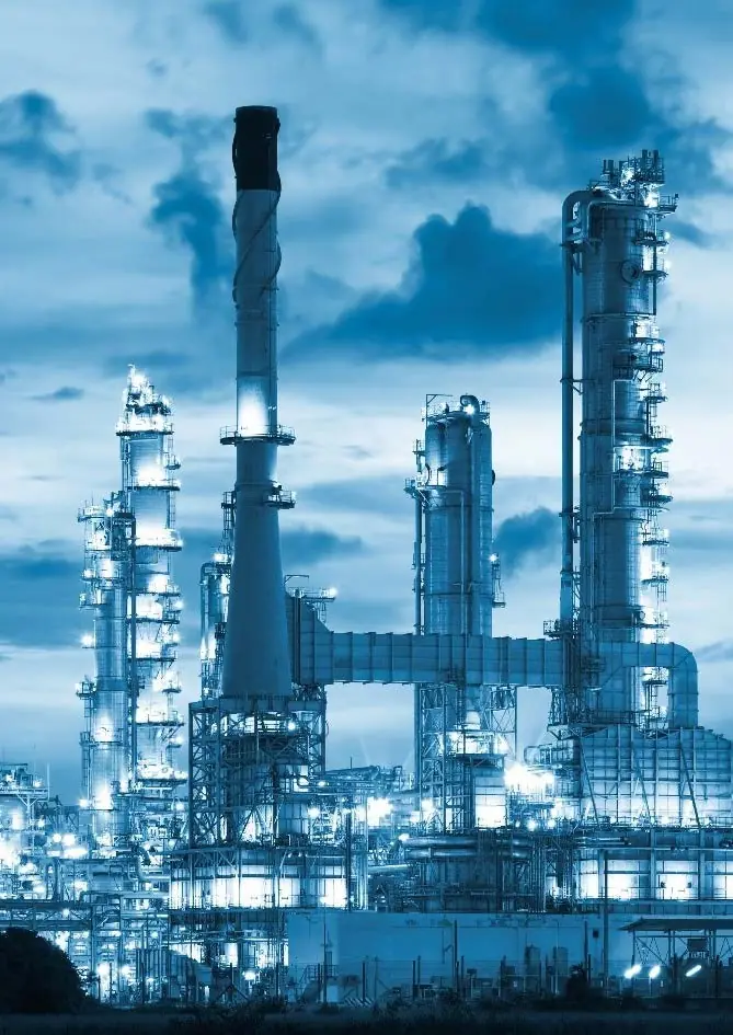Refinery towers and stacks against a blue sky